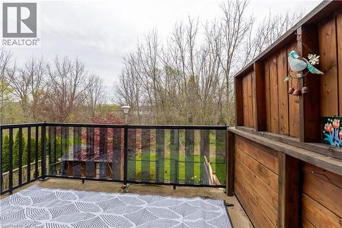Private outdoor deck featuring a glass and metal railing, wood privacy wall, and concrete flooring - 4066 Medland Drive, Burlington, ON - Outdoor