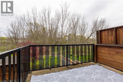 Outdoor balcony with concrete flooring, framed by black metal railings with glass panels - 4066 Medland Drive, Burlington, ON - Outdoor