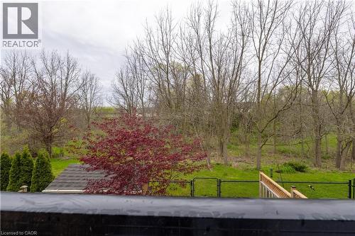 Expansive backyard with a manicured lawn, established trees, and a vibrant red-leafed tree - 4066 Medland Drive, Burlington, ON - Outdoor