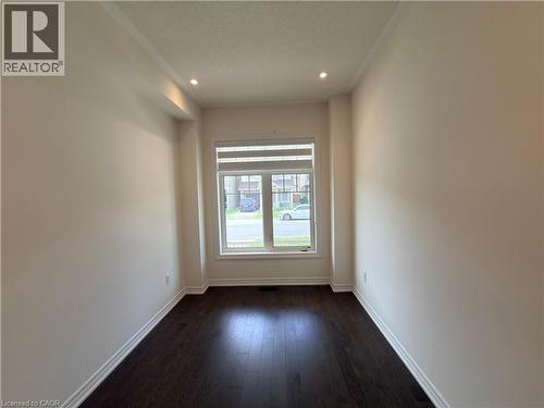 Room with wood-finish flooring, recessed lighting, and a large window with horizontal blinds - 3948 Thomas Alton Boulevard, Burlington, ON - Indoor Photo Showing Other Room