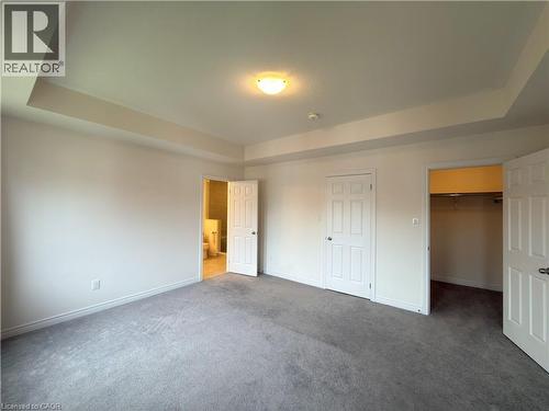 Carpeted room featuring a tray ceiling, recessed lighting, and white baseboards - 3948 Thomas Alton Boulevard, Burlington, ON - Indoor Photo Showing Other Room