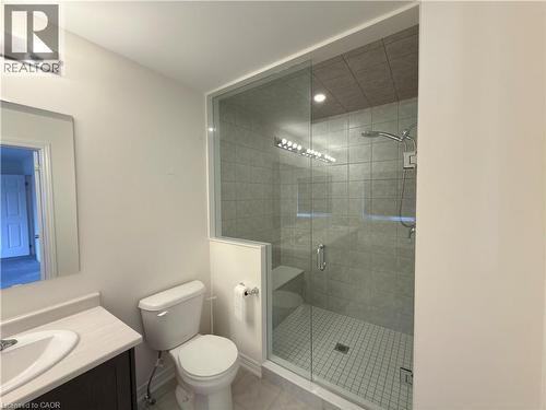 Glass-enclosed shower with a tiled bench, rain shower head, and an additional wall-mounted shower head - 3948 Thomas Alton Boulevard, Burlington, ON - Indoor Photo Showing Bathroom