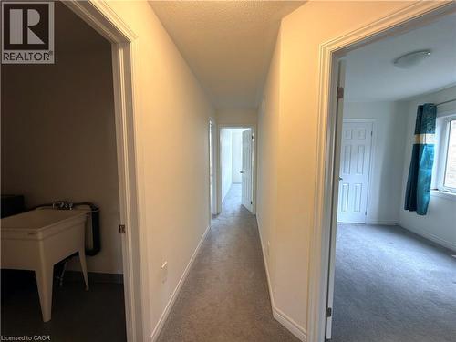 Hallway featuring neutral-toned carpeting and white painted walls - 3948 Thomas Alton Boulevard, Burlington, ON - Indoor Photo Showing Other Room