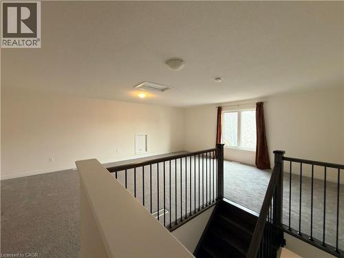 Upper-level loft space featuring neutral carpeting and light-toned walls - 3948 Thomas Alton Boulevard, Burlington, ON - Indoor Photo Showing Other Room