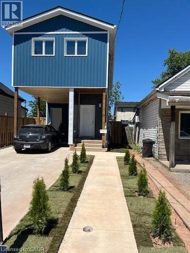 Contemporary two-story exterior with blue vertical siding and white trim - 85 Albany Avenue, Hamilton, ON 