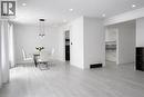 Open-concept living space featuring light wood-finish flooring, recessed lighting, and crown molding - 84 Elgar Avenue, Hamilton, ON 