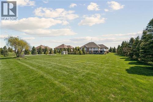 Expansive lawn area with mature trees bordering the property - 10 Brolley Crescent, Thornton, ON - Outdoor With View
