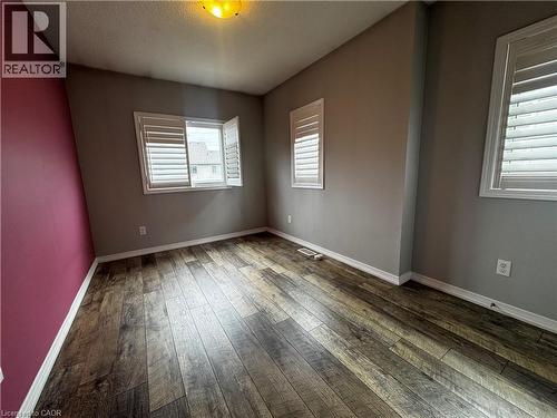 Room featuring wood-finish flooring, white baseboards, and neutral wall tones - 13 Sorrento Street, Kitchener, ON - Indoor Photo Showing Other Room