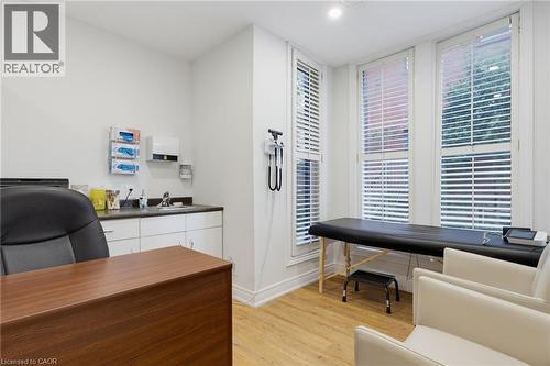 Room #3 -Professionally Equipped/Furnished Office space featuring sink and counter-top, and built-in cabinetry with four tall windows with plantation shutters, wood-finish flooring, recessed lighting. - 189 Hughson Street, Hamilton, ON 
