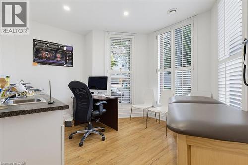 Room #1 -Professionally Equipped/Furnished Office space featuring sink and counter-top, and built-in cabinetry with three tall windows with plantation shutters, wood-finish flooring, recessed lighting - 189 Hughson Street, Hamilton, ON 