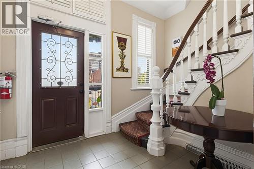 Entry foyer featuring a decorative glass-panel door, transom window, and tile flooring - 189 Hughson Street, Hamilton, ON 