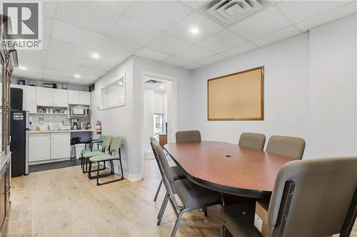 Conference room with light wood-finish flooring and a drop ceiling with recessed lighting - 189 Hughson Street, Hamilton, ON 
