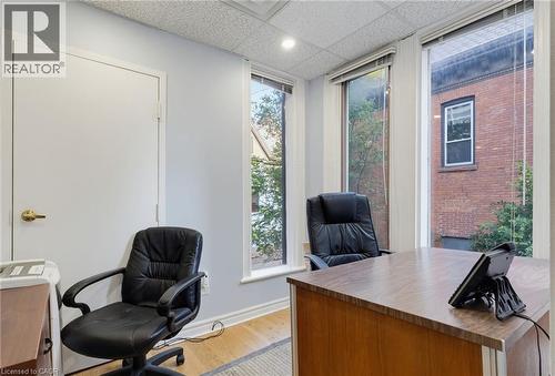 Bright office space featuring multiple windows, light blue wall paint, and wood-finish flooring - 189 Hughson Street, Hamilton, ON 