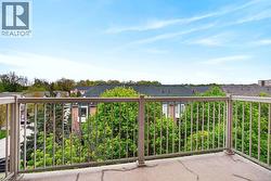 Balcony featuring a light-colored railing and concrete flooring - 