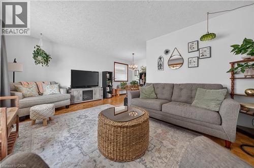 Spacious living area featuring light-colored walls and wood-finish flooring - 111 Kimberly Crescent, Kitchener, ON 