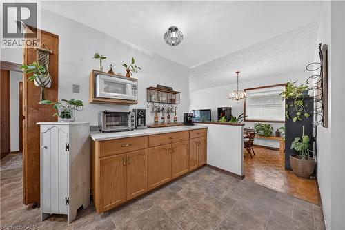 Kitchen featuring light wood cabinetry, light-toned countertop, and durable tile flooring - 111 Kimberly Crescent, Kitchener, ON 