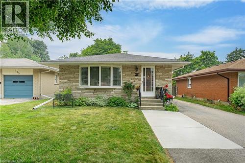 Stone veneer exterior with a bay window, concrete walkway, and paved driveway - 111 Kimberly Crescent, Kitchener, ON 