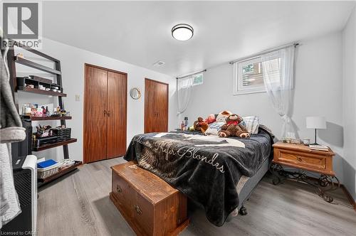 Interior space featuring wood-finish flooring, white walls, and a flush-mount ceiling light - 111 Kimberly Crescent, Kitchener, ON 