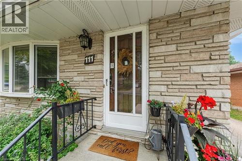 Front entrance featuring stone veneer siding, a bay window, and a white screen door - 111 Kimberly Crescent, Kitchener, ON - Outdoor With Exterior