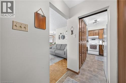 Kitchen featuring wood-finish cabinetry, white appliances, and tiled flooring - 111 Kimberly Crescent, Kitchener, ON - Indoor Photo Showing Other Room