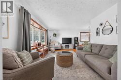 Living room featuring neutral wall tones and a textured ceiling - 