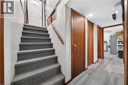 Carpeted staircase with wood-finish handrail - 111 Kimberly Crescent, Kitchener, ON - Indoor Photo Showing Other Room