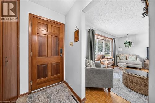 Solid wood paneled entry door with dark hardware - 111 Kimberly Crescent, Kitchener, ON 