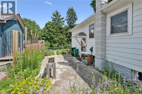 Stone veneer chimney accenting white siding - 95 Forest Road, Cambridge, ON - Outdoor