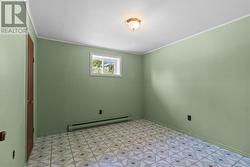 Bright lower-level bedroom perfect for family or guests. - 