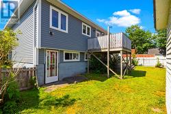 Rear exterior showcasing the walk out lower level and outdoor living space. - 