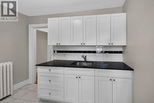 Contemporary white cabinetry with a black countertop and stainless steel sink - 103 Mary Street, Hamilton, ON - Indoor Photo Showing Kitchen