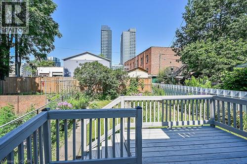 Spacious outdoor deck with painted wood railing overlooking a verdant yard - 103 Mary Street, Hamilton, ON - Outdoor