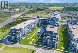 Contemporary multi-story residential buildings featuring balconies and a central courtyard with an outdoor swimming pool - 