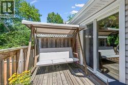 Outdoor wooden deck featuring a privacy fence and sliding glass door access - 