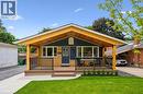 Ranch-style exterior with yellow brick and dark blue siding - 223 Carter Avenue, Waterloo, ON  - Outdoor With Deck Patio Veranda 