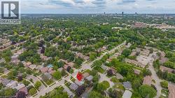 Aerial perspective showcasing a residential neighborhood with a dense tree canopy - 
