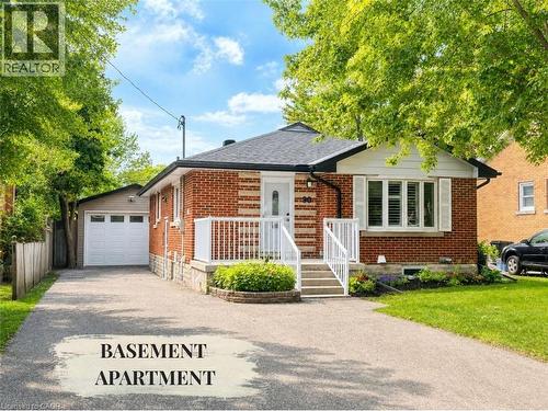 Red brick bungalow with a white front door and storm door - 90 Arlington Boulevard Unit# Bsmt, Kitchener, ON - Outdoor