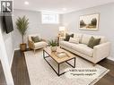 Spacious living area featuring recessed lighting, dark wood-finish flooring, a neutral color palette, and a window providing natural light - 90 Arlington Boulevard, Kitchener, ON  - Indoor Photo Showing Living Room 