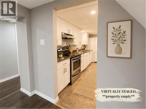 Kitchen featuring white cabinetry, stainless steel appliances, and a tile floor - 90 Arlington Boulevard, Kitchener, ON - Indoor Photo Showing Kitchen