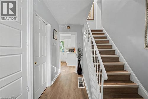 Staircase with wood-finish treads and white risers, featuring a white baluster railing - 47 Bowman Street, Hamilton, ON - Indoor Photo Showing Other Room