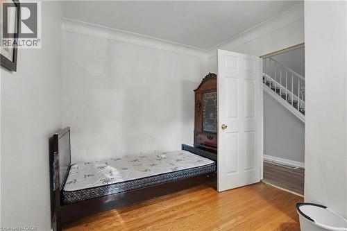 Hardwood flooring throughout, white baseboards, and crown molding - 47 Bowman Street, Hamilton, ON - Indoor