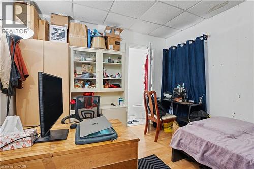 Wood-finish flooring with white walls and a drop ceiling - 47 Bowman Street, Hamilton, ON - Indoor Photo Showing Bedroom