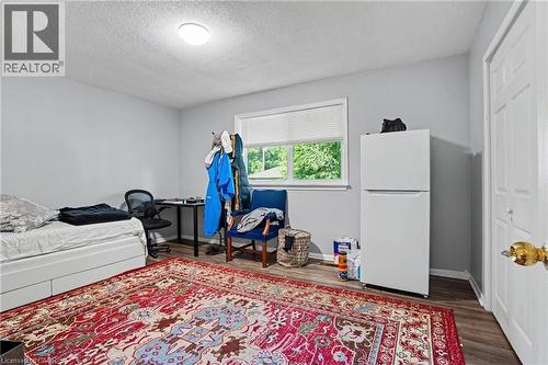 Room featuring light grey walls, wood-finish flooring, and a single window with blinds - 47 Bowman Street, Hamilton, ON - Indoor Photo Showing Bedroom