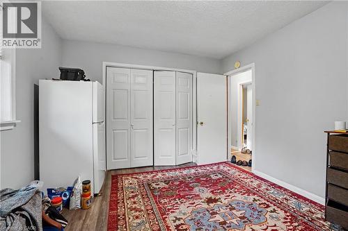 Interior room featuring light gray wall paint, wood-finish flooring, and white bi-fold closet doors - 47 Bowman Street, Hamilton, ON - Indoor