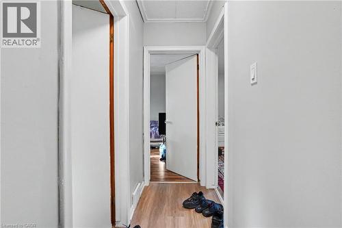 Hallway featuring wood-finish flooring, light-toned walls, and multiple doorways - 47 Bowman Street, Hamilton, ON - Indoor Photo Showing Other Room
