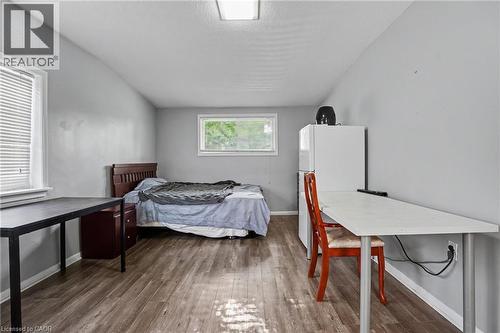 Spacious room featuring wood-finish flooring and light gray walls - 47 Bowman Street, Hamilton, ON - Indoor Photo Showing Bedroom
