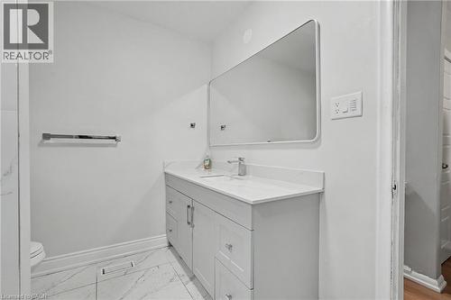 Modern bathroom vanity featuring a white countertop with integrated sink and chrome faucet - 47 Bowman Street, Hamilton, ON - Indoor Photo Showing Bathroom