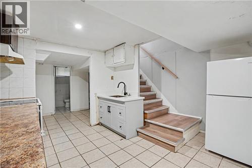 Tiled flooring spanning the visible area, with a white two-door refrigerator - 47 Bowman Street, Hamilton, ON - Indoor Photo Showing Kitchen