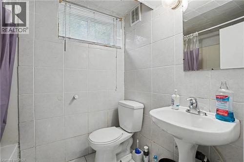 Bathroom featuring light-toned tile walls and flooring - 47 Bowman Street, Hamilton, ON - Indoor Photo Showing Bathroom