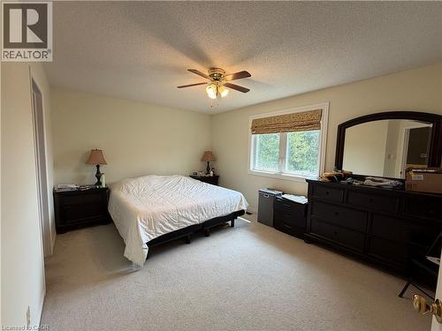 Carpeted room with a ceiling fan, a window featuring a patterned Roman shade, and light-toned walls - 436 Gatestone Boulevard, Waterloo, ON - Indoor Photo Showing Bedroom